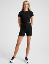 black high-waisted 5" inseam biker shorts with pockets and a drawstring at waistband.